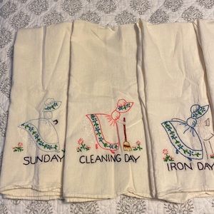 7 vintage linen tea towels, hand embroidered.